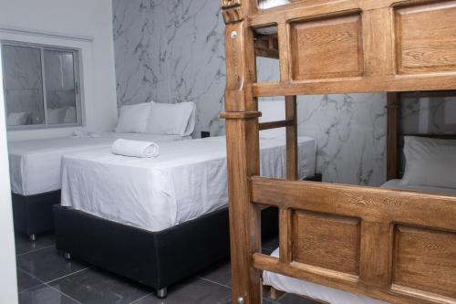a bedroom with a bunk bed and a ladder at Hotel Mall plaza in Santa Marta
