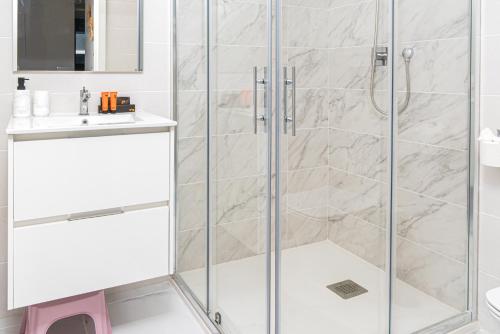 a shower with glass doors in a bathroom at Azure Libra Apartment Flamenca Village in Orihuela Costa