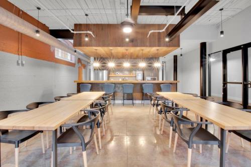 a dining room with wooden tables and chairs at Urban Escape Industrial 2BR 2BA in Greenville