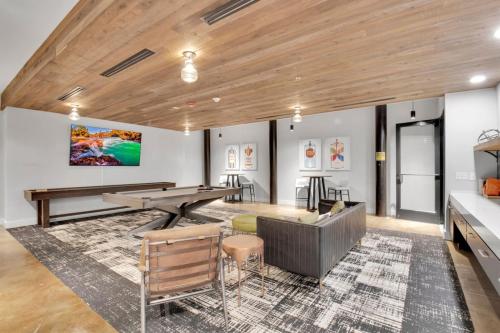 a room with a ping pong table and chairs at Urban Escape Industrial 2BR 2BA in Greenville