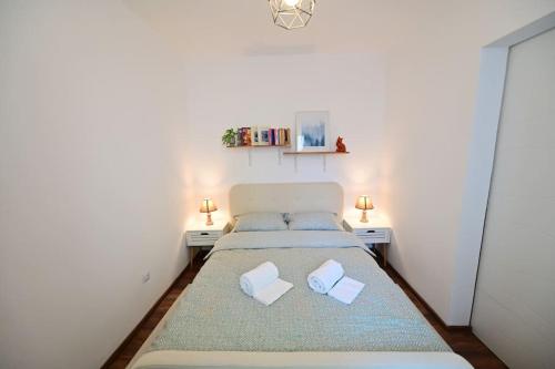 a small bedroom with a bed with two pillows at FLH - The Great Novel in Sibiu