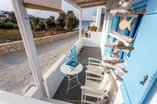 a view from the balcony of a house with a table and chairs at Ammos Studios in Donoussa