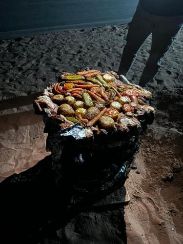 a pile of food sitting on the beach at Rum Angel Camp in Wadi Rum