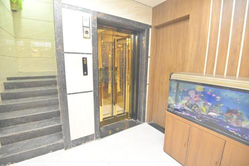 a hallway with a fish tank in a building at Hotel JK palace in Allahābād