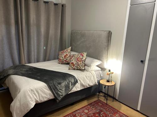 a small bedroom with a bed with a window at Cedara Way Hilton in Hilton