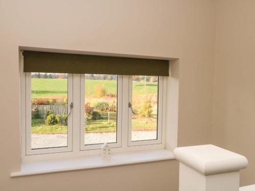 a window in a room with a window blind at Yocking Gate Mews in Whitchurch