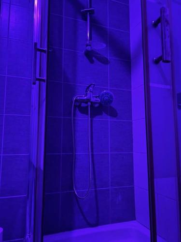 a bathroom with a shower with a blue light at Love-cocon sur mantes sur mante in Mantes-la-Jolie