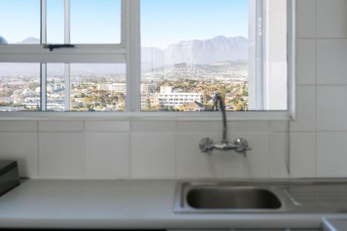 a kitchen sink with a view of a city at Odeon Towers 1102 in Strand