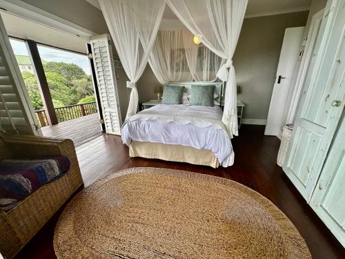 a bedroom with a bed and a large window at Mar Azul 15 in Ponta Malongane