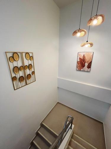 a room with a staircase with two pendant lights at Sleeping Shine by DeliZia Satun พักได้ 8-9 ท่าน in Satun