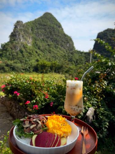 a plate of food and a drink on a table at Yangshuo Hillside Homestay in Yangshuo
