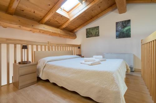 a bedroom with a large bed and a skylight at Agriturismo Il Pianetto in Verona