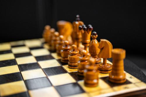 a chess board with wooden chess pieces on it at LivingRoom Oficyna Self Check-in 24h in Katowice