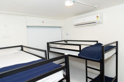 a room with three bunk beds in it at Slackpackr Hyderabad in Hyderabad