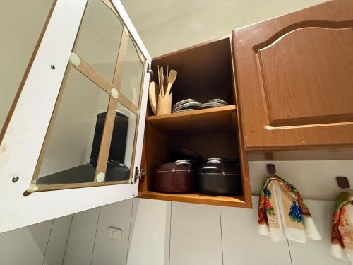 a kitchen cabinet with a mirror and some dishes at Mayama airport apartment in Accra