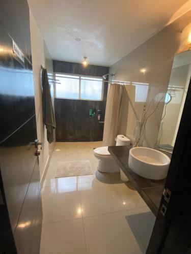 a bathroom with a sink and a toilet at Estancia Iturriaga Suite 2 in Mexico City