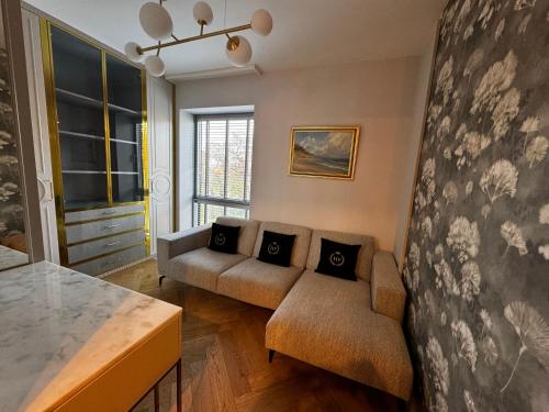 a living room with a couch and a table at Apartament Faltom 6 Yacht Park Premium in Gdynia