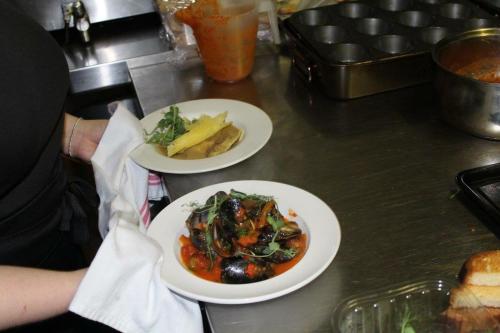 a person holding two plates of food on a counter at The Nags Head Tredegar in Nant-y-bwch