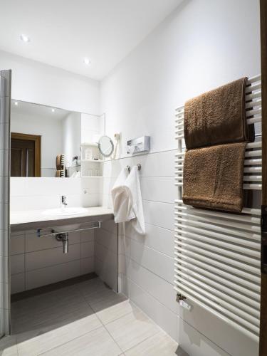a bathroom with a sink and a mirror at Landhaus Müllenborn in Gerolstein