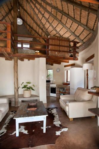a living room with a couch and a table at Dalmore Guest Farm in Bergville