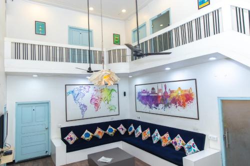 a room with a blue bench with pillows at Slackpackr Hyderabad in Hyderabad