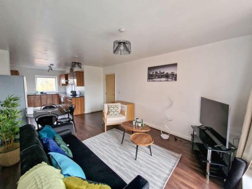 a living room with a couch and a table at Lovely 3 Bed Close to Centre by City SuperHost in Manchester