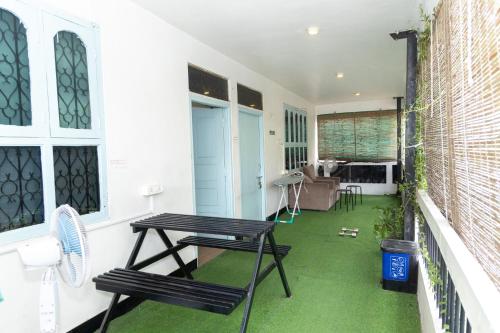 a patio with a table and chairs on a house at Slackpackr Hyderabad in Hyderabad