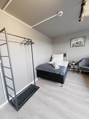 a bedroom with a bed and a ladder in it at E18rom Motell in Tønsberg