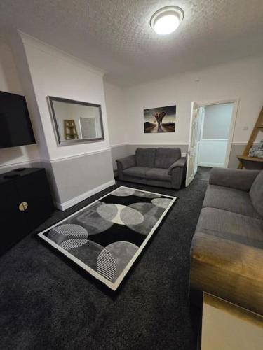 a living room with a couch and a rug at Levy Nook House 1 bed apartment 5 minute walk to Stockton town centre & Free Parking in Stockton-on-Tees