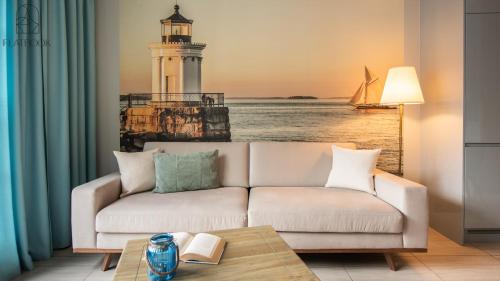 a living room with a white couch and a lighthouse at Flatbook - City Center SPA Apartments 6B,C in Gdańsk