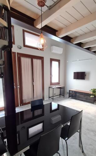 a large room with a black table and chairs at Elements Orio - Rooms & Apartments in Orio al Serio