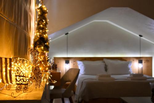 a bedroom with a large bed with christmas lights at Panellinion Luxury Rooms in Kalamata