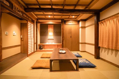 a room with a table in the middle of a room at 都電屋 TodenHotel in Tokyo