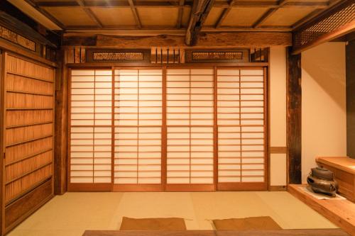 a japanese room with a large door in a room at 都電屋 TodenHotel in Tokyo