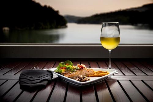 a plate of food and a glass of wine on a table at Fox Run at Lake Lure in Lake Lure