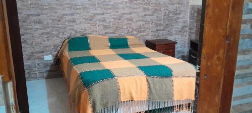 a bed in a room with a mirror at Casa Quequén in Quequén