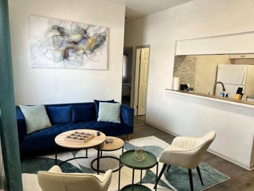a living room with a blue couch and chairs at Affordable Stay Near Proctors A2 in Schenectady