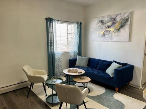 a living room with a blue couch and a table at Affordable Stay Near Proctors A2 in Schenectady