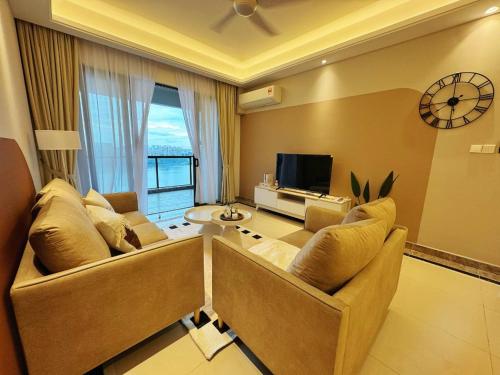 a large living room with a couch and a tv at TheBess Hotel Tokyo is located adjacent to Singapore and offers a sea viewIt is a family business smart room with the sea view of Princess Bay富力公主湾 in Johor Bahru