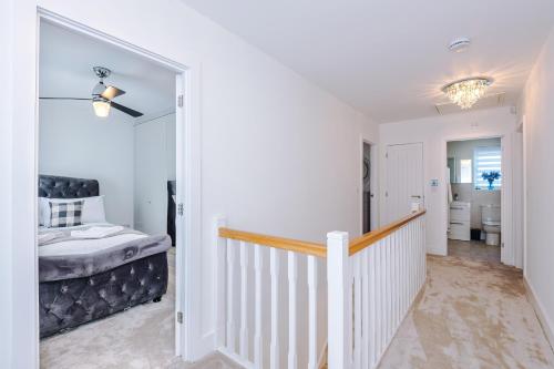 a white hallway with a stairway leading to a bedroom at Hasting's House by YourStays - 3 Bedroom House in Stoke-on-Trent in Stoke on Trent
