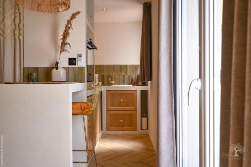 a small kitchen with a counter and a sink at Une perle au bord de l'eau in La Ciotat