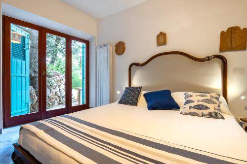 a bedroom with a large bed and a window at Dimora Punta Rossa in San Felice Circeo