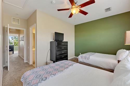 a bedroom with two beds and a ceiling fan at Vista Cay Resort, Next To Universal #821 in Orlando