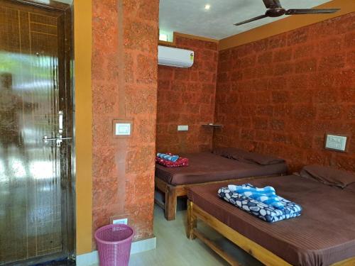 a room with two beds in a room at Palm Beach Resort in Kumta