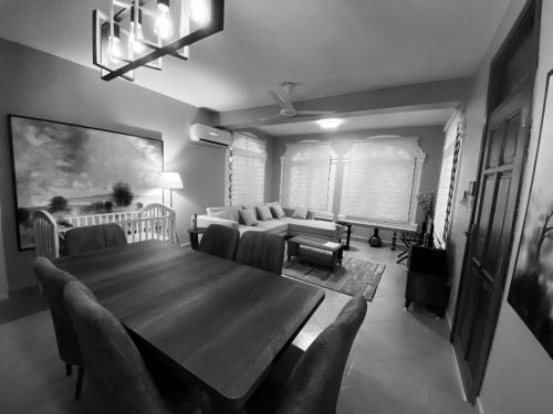 a living room with a wooden table and a couch at Jacomo Residences in Dar es Salaam