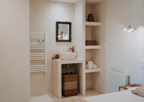 une salle de bain avec un lavabo et un miroir dans l'établissement Lou Baïto - Logement de Charme vue Luberon, à La Tour-dʼAigues