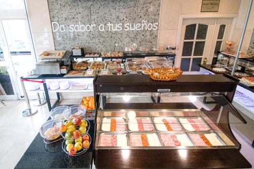a buffet line with food on display in a store at Hoteles Urbanos N Avenida de España in Fuenlabrada