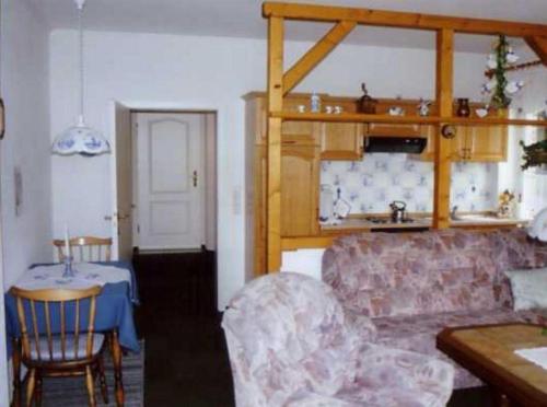 a living room with a couch and a table at Unterm-Reetdach-Whg-5-unten-links in Borkum
