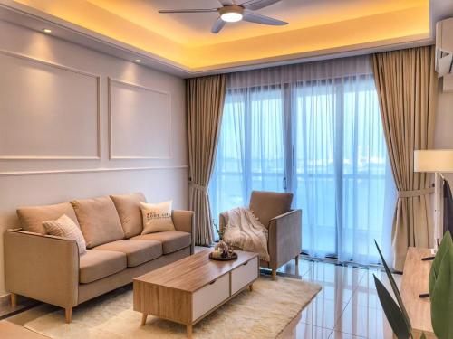 a living room with a couch and a table at TheBess Hotel Tokyo is located adjacent to Singapore and offers a sea viewIt is a family business smart room with the sea view of Princess Bay富力公主湾 in Johor Bahru
