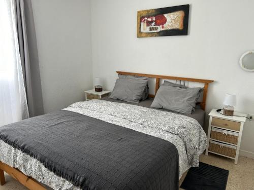 a bedroom with a bed and two night stands at Casita Lola Sol in Puntillo del Sol